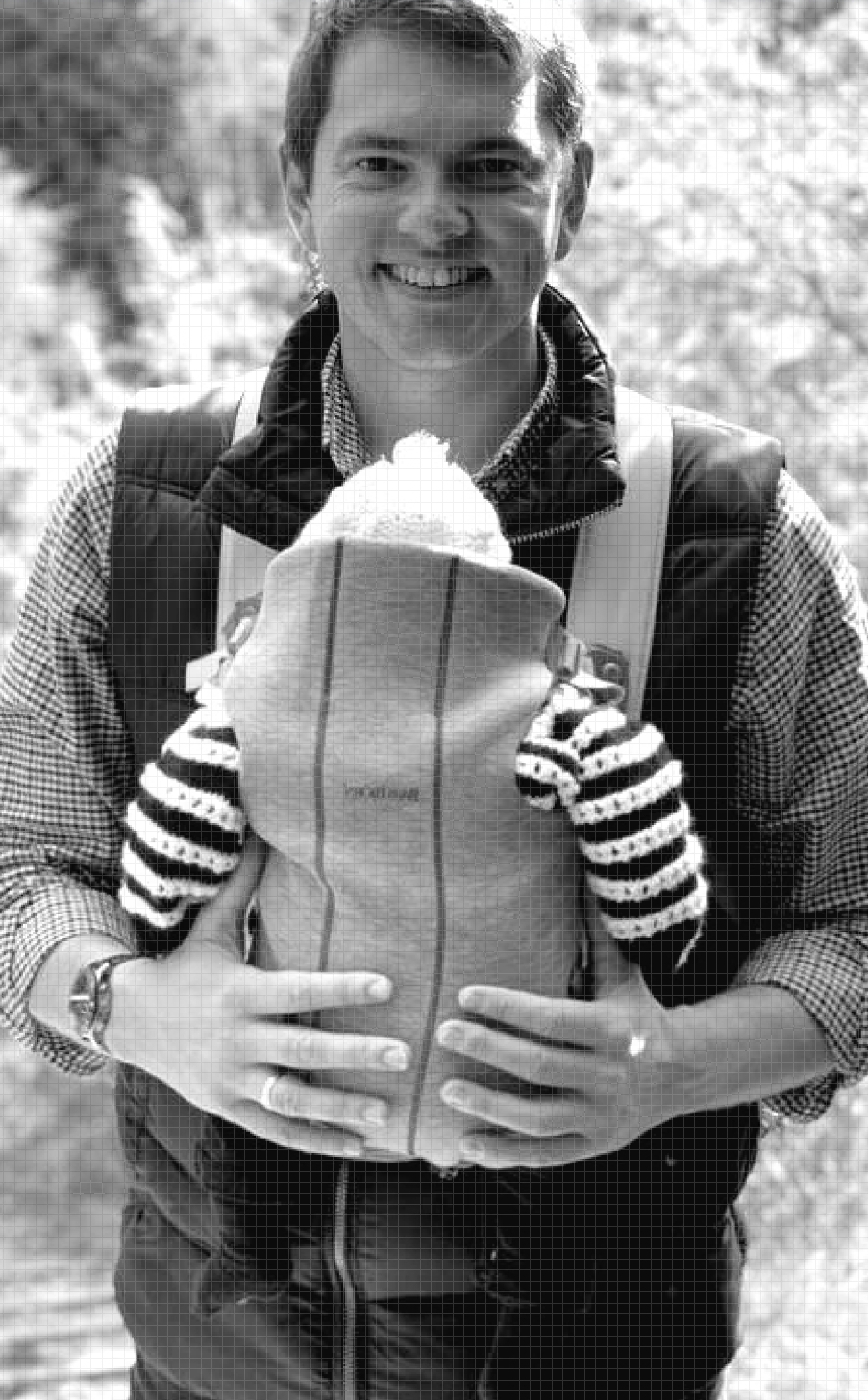 Portrait of co-founder Paul wearing his first child in a baby carrier.